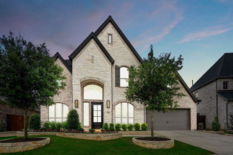 This modern 2 story home boasts great curb appeal with beautiful lush landscaping and a well-manicured front lawn. You're welcomed by an elegant exterior with cream stone and contrasting dark trim and shutters, warm brick, and a spacious 3 car garage!

