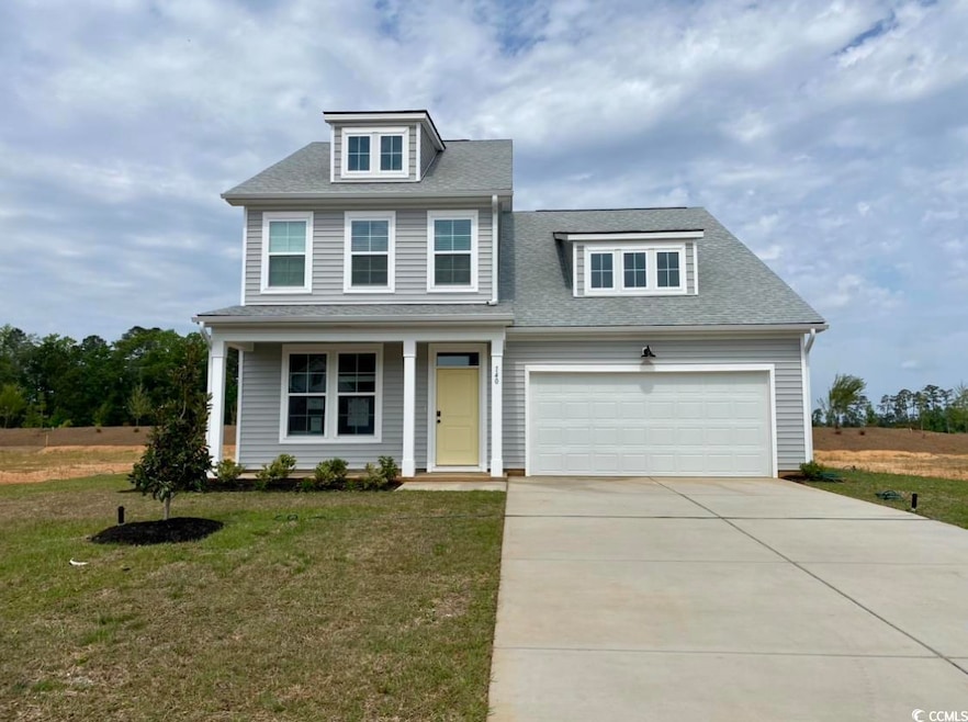 View of front of home featuring a shingled roof, driveway, covered porch, and a front yard