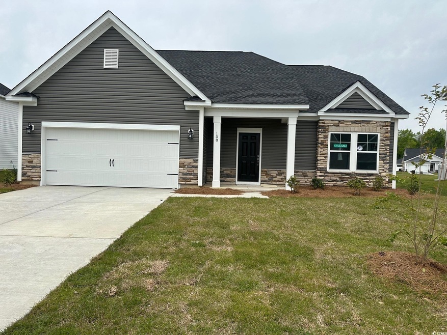 Craftsman house with roof with shingles, a front yard, stone siding, an attached garage, and driveway