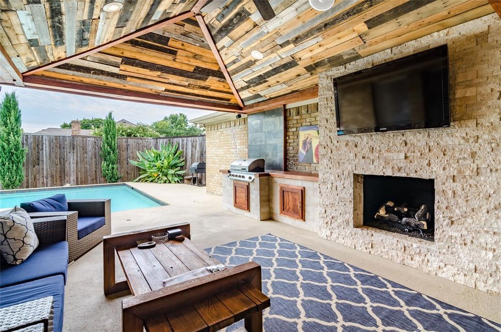 Custom covered patio with outdoor kitchen, firepla