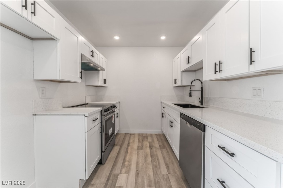 Kitchen with a sink, under cabinet range hood, app