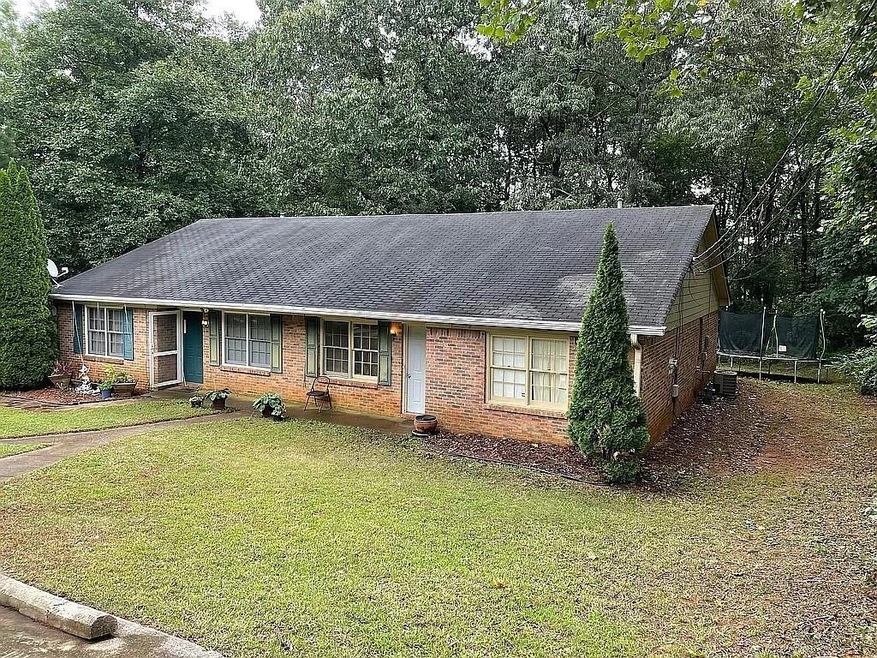 Single story home with central AC unit, a trampoli
