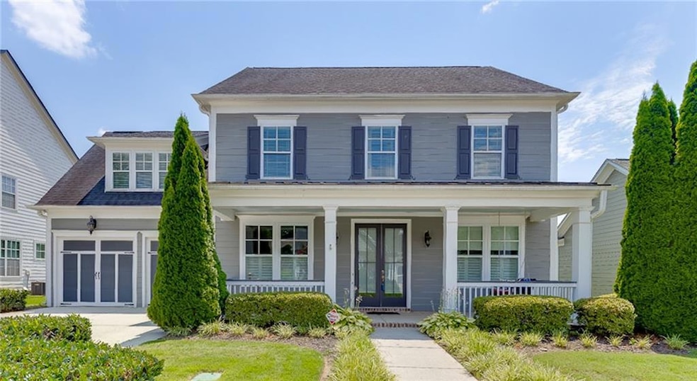 View of front of house with a porch and a garage