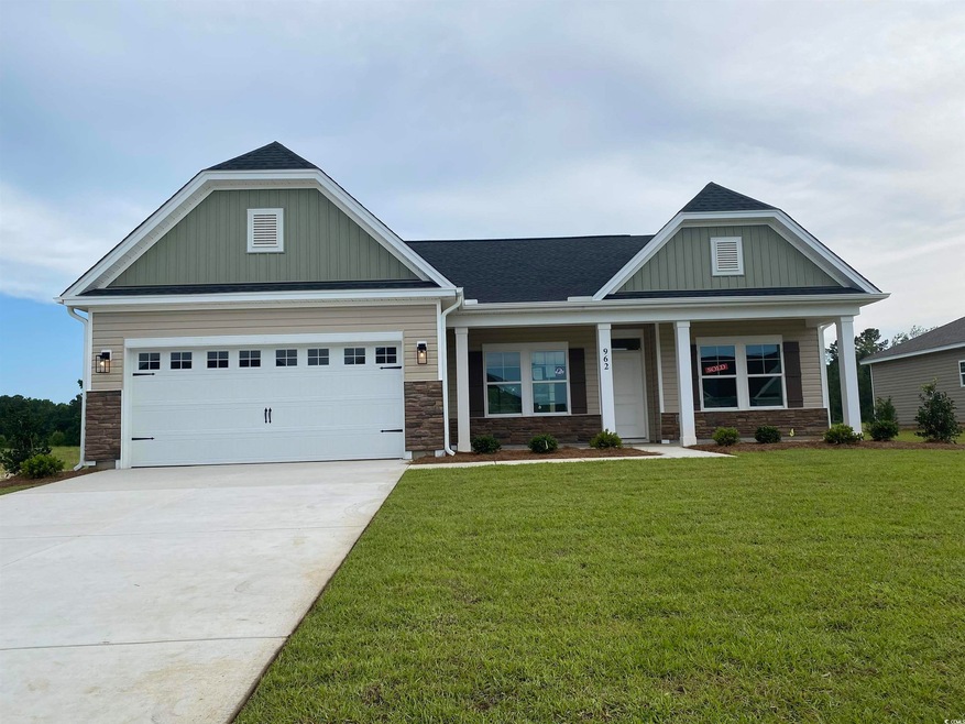 Craftsman inspired home with a front lawn, board and batten siding, stone siding, concrete driveway, and a porch