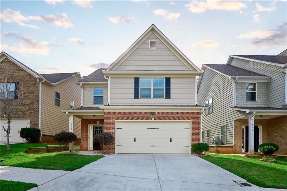 View of front facade with a garage and a front yard