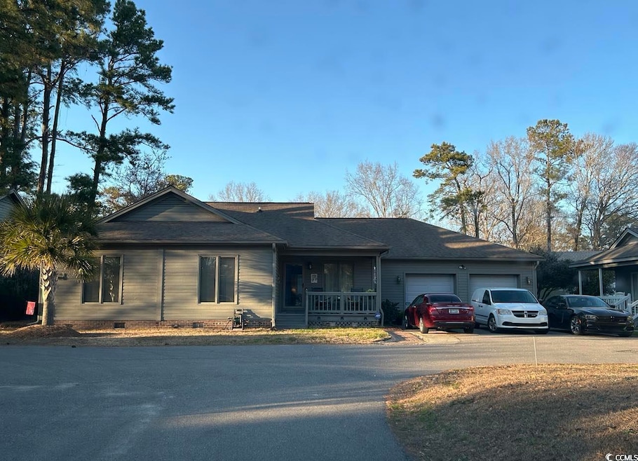 Single story home featuring a garage, asphalt driveway, crawl space, covered porch, and a shingled roof
