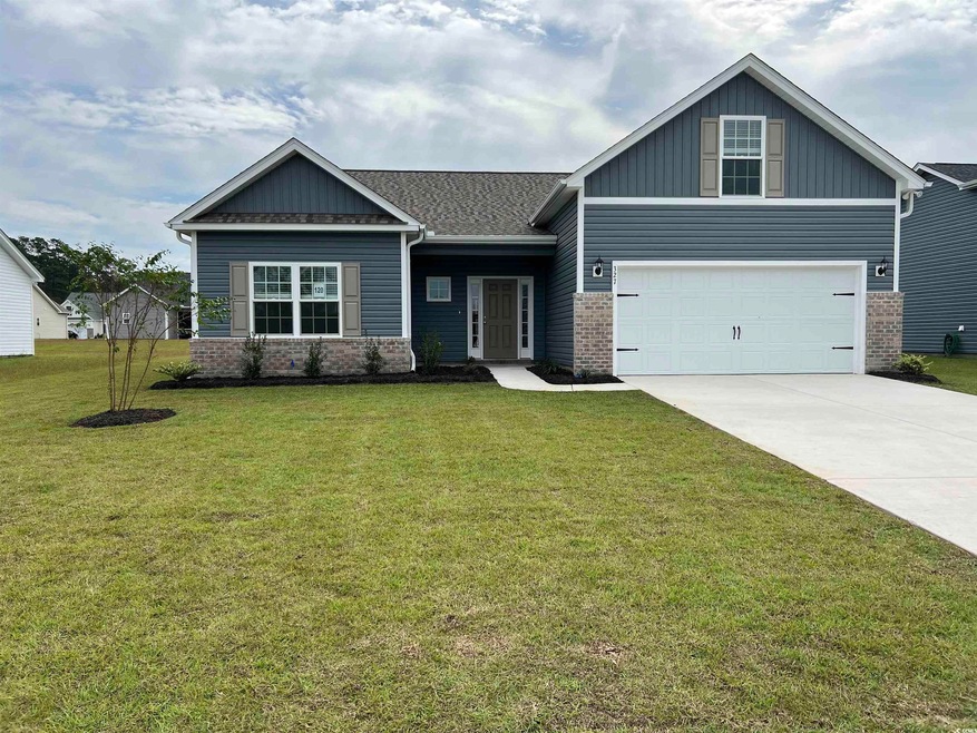 Craftsman-style home with a front yard and a garag