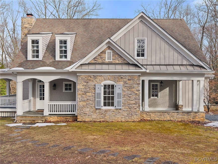 View of front of home with a porch and a front law
