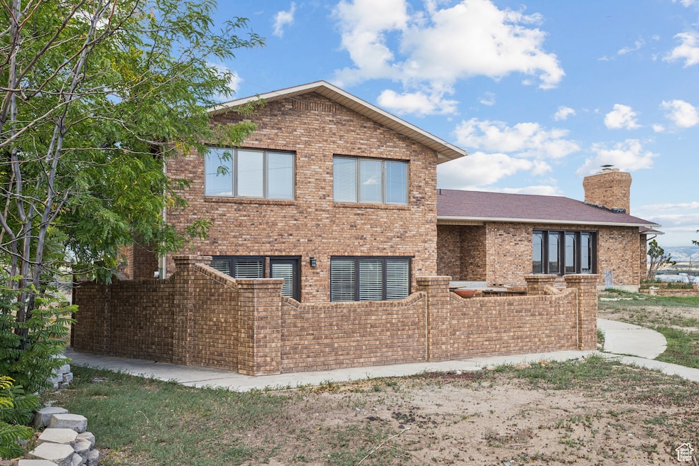 View of front facade featuring brick siding and a chimney