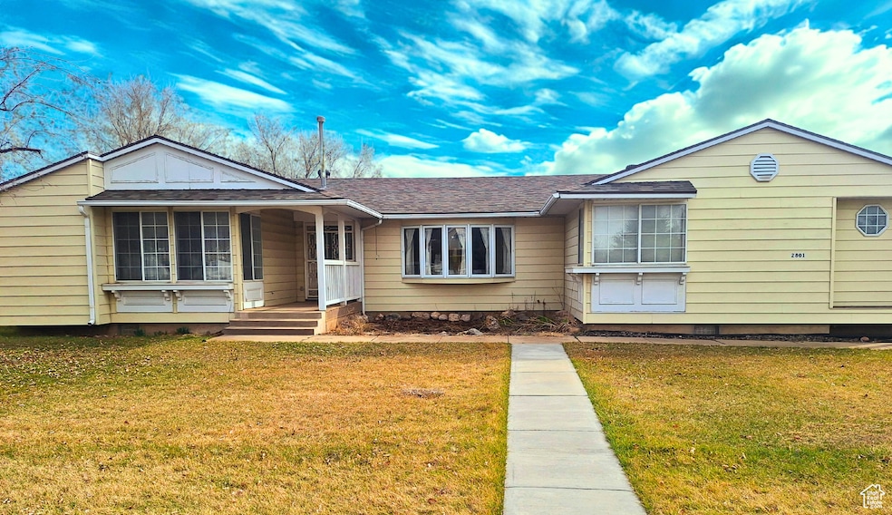 Single story home with a front lawn, roof with shingles, crawl space, and a porch
