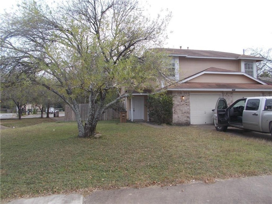 View of front of home with a front yard and brick