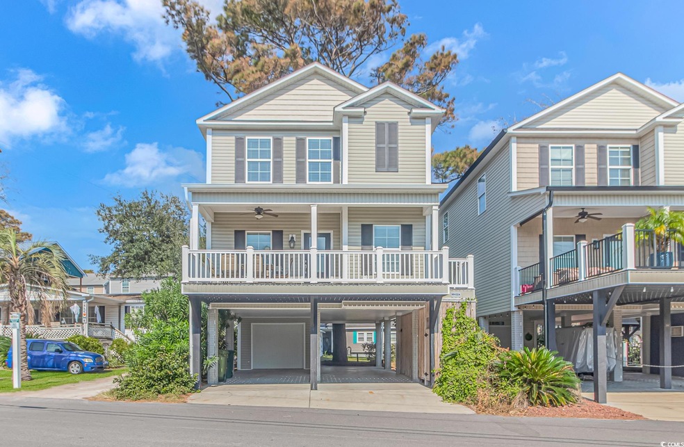View of front of house with ceiling fan, a garage,