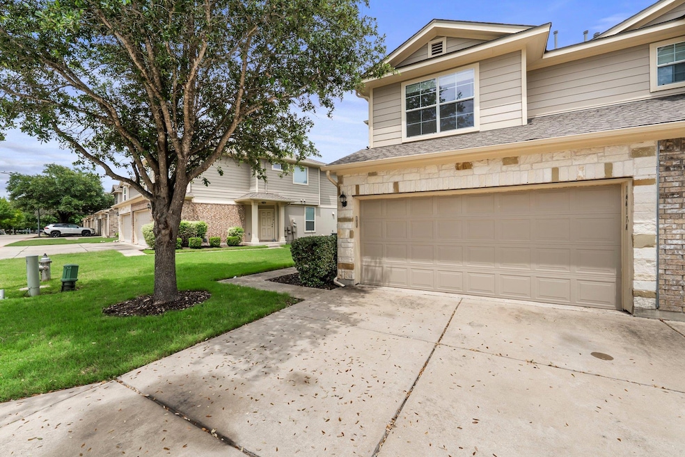 View of front of property with driveway, stone si