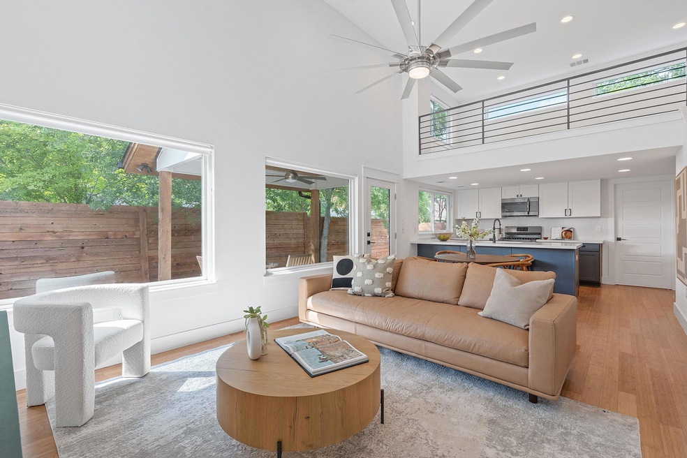 Living area featuring light wood-style floors, ce