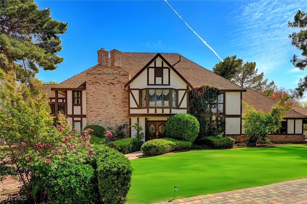 View of front of house with a front lawn, brick si