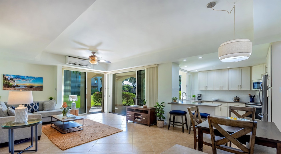 a spacious covered lanai surrounded by tropical landscaping & a manicured lawn.