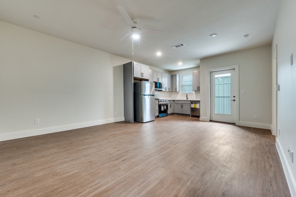 Unfurnished living room featuring light wood-style flooring, ceiling fan, and recessed lighting