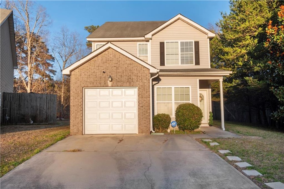 Traditional-style house with concrete driveway, fe