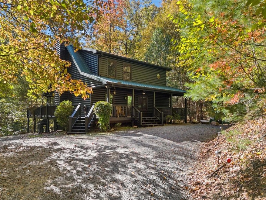 Log-style house featuring a porch