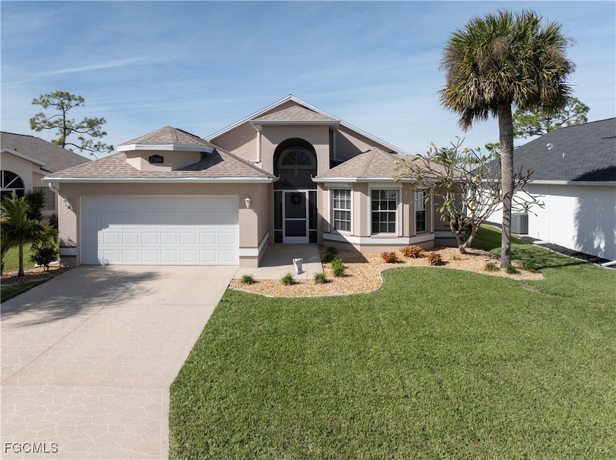 Single story home with a shingled roof, stucco siding, concrete driveway, a garage, and a front yard