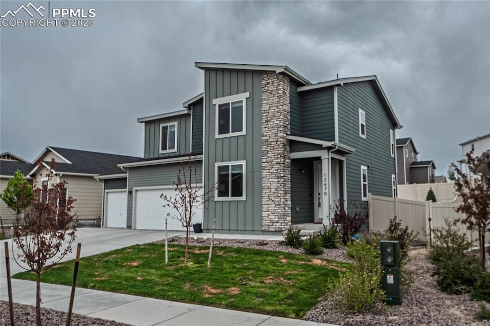 View of front of house featuring board and batten siding, concrete driveway, and a garage