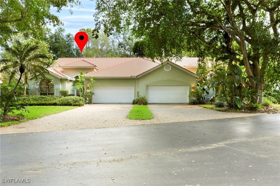 View of front of property with a tile roof, paver