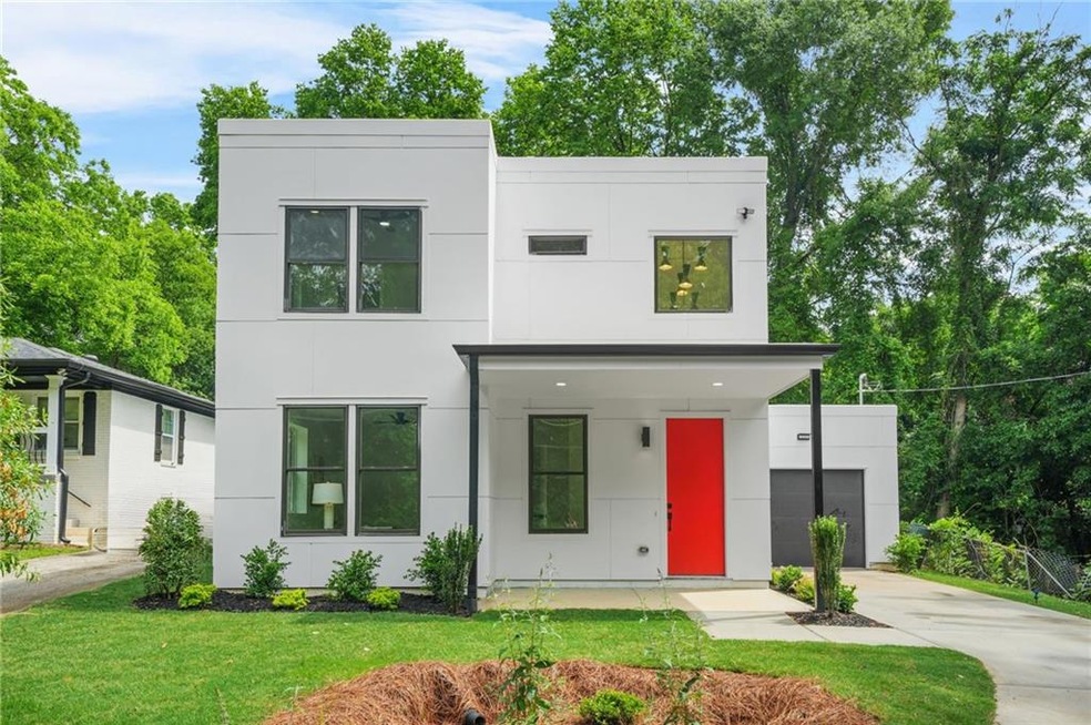 Contemporary house with stucco siding, driveway, and a front yard