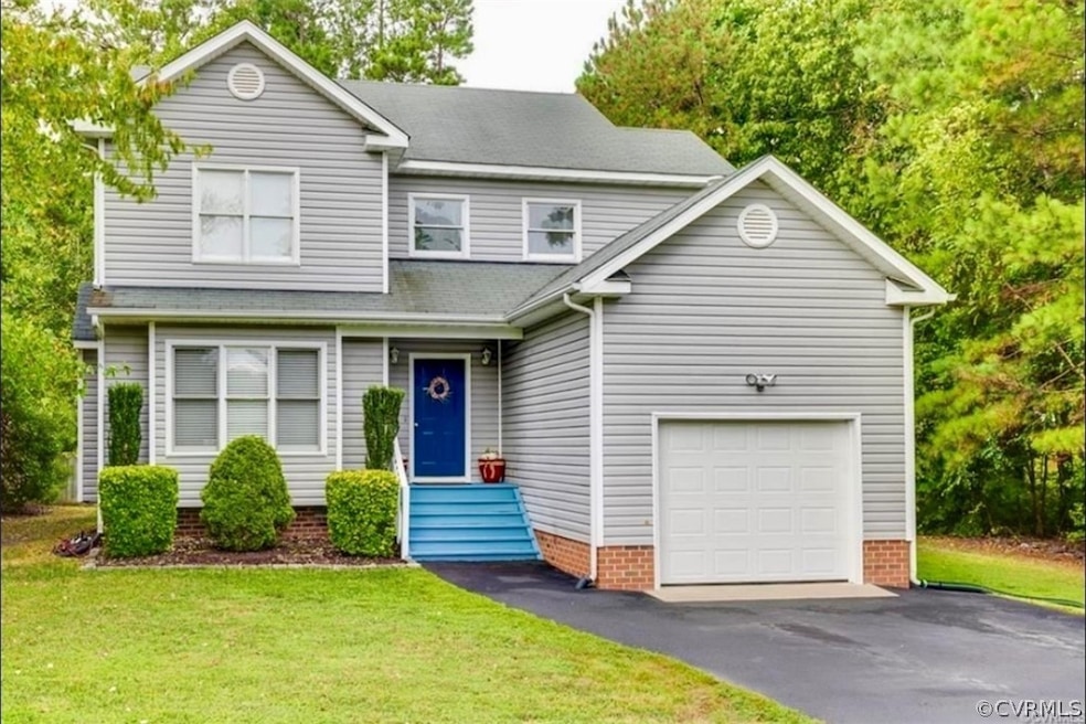 View of front of property featuring a garage and a