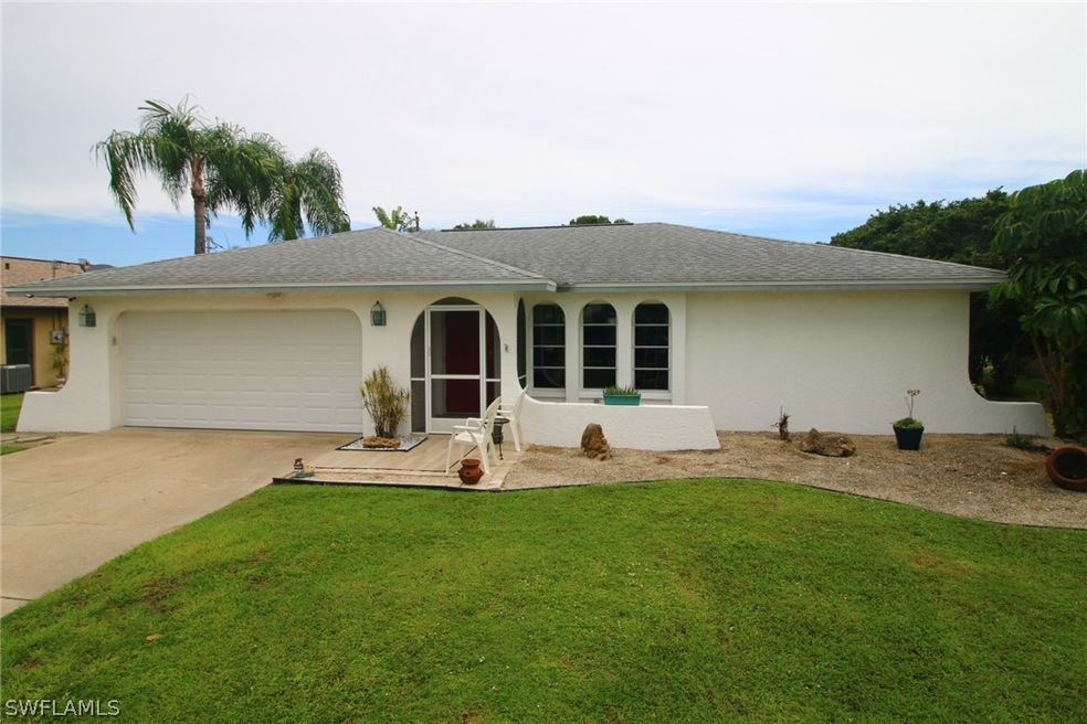 Front of this 1,469 square foot, 3 bedroom, 2 bathroom pool home with a screened-in front entry.