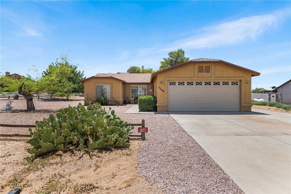 Ranch-style house with stucco siding, concrete driveway, and an attached garage