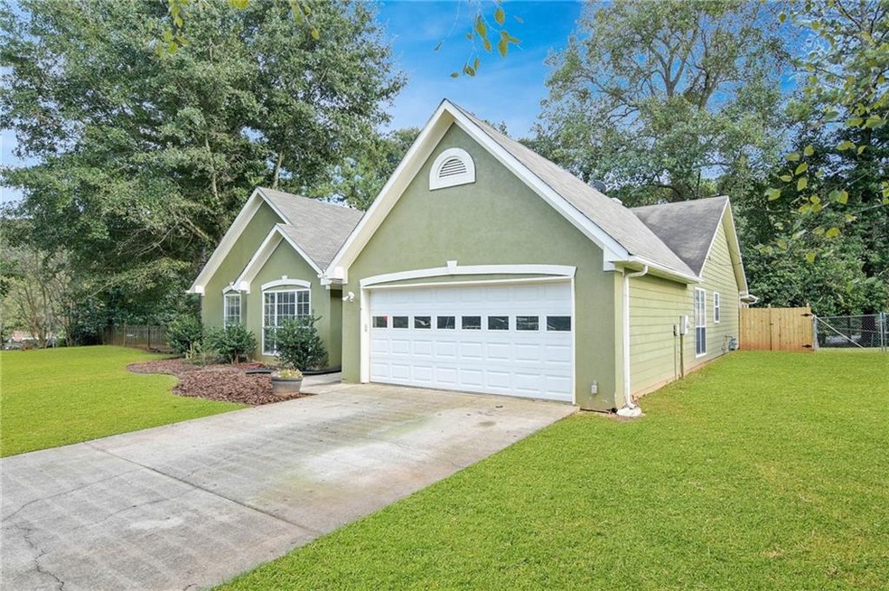 Front corner showing the side yard.