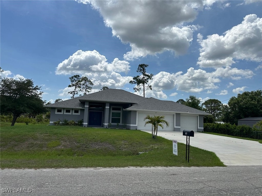 View of front of property with a garage, driveway,