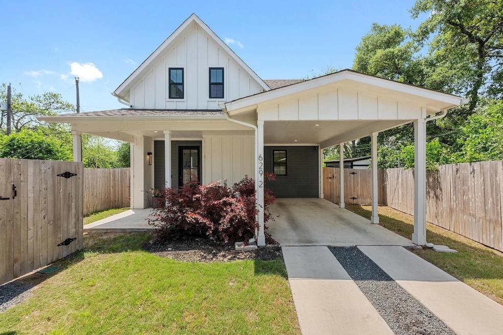 View of front of house featuring fence, a front l