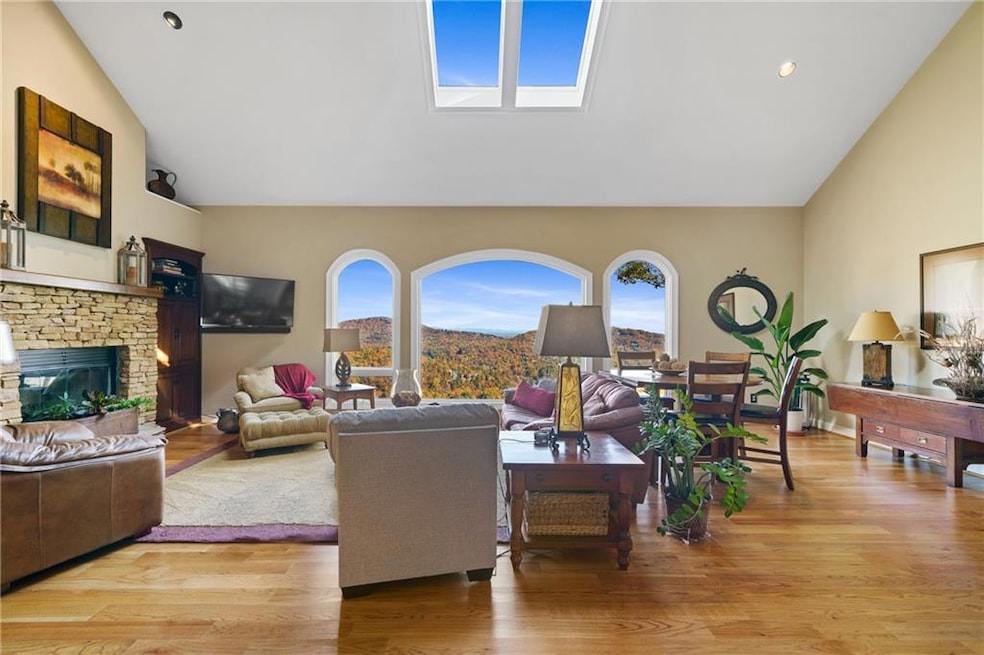 Heart of this beautiful home is the spacious and light 2-story Great Room...Features include cathedral, beamed ceiling with double skylights, hardwood floor, large stacked-stone fireplace - and a wall of windows that flood the Living Area with natura