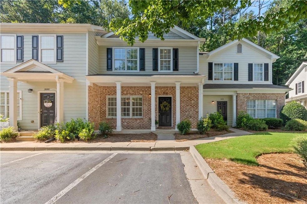 Multi unit property featuring brick siding and uncovered parking