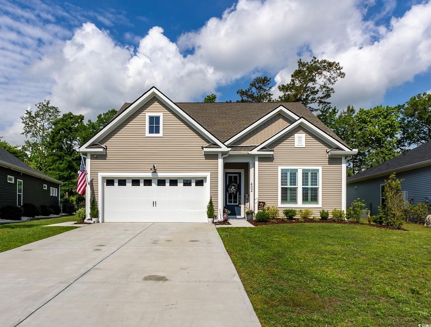 Craftsman inspired home with a garage, driveway, a