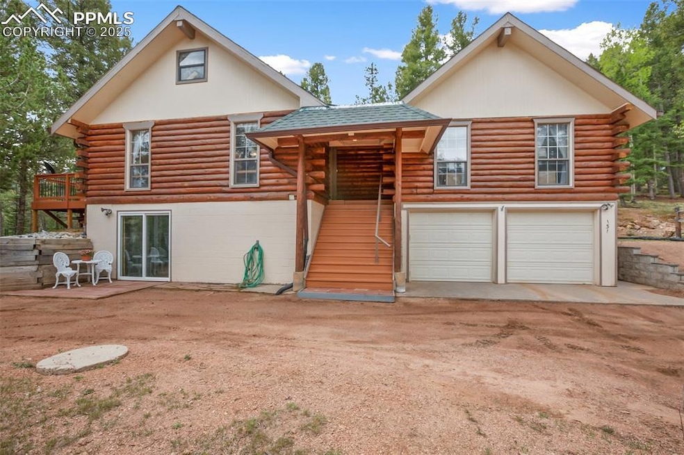 View of front facade featuring log siding, stairs, a garage, driveway, and a shingled roof