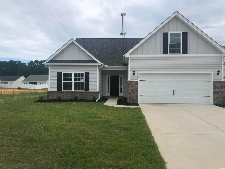 Craftsman house with a garage and a front yard