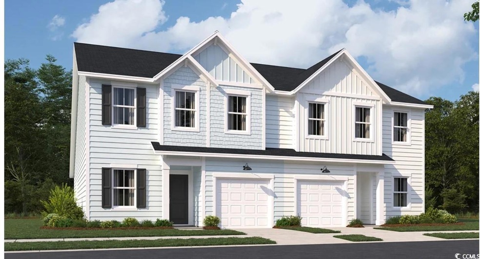 Townhome / multi-family property with board and batten siding, an attached garage, and concrete driveway