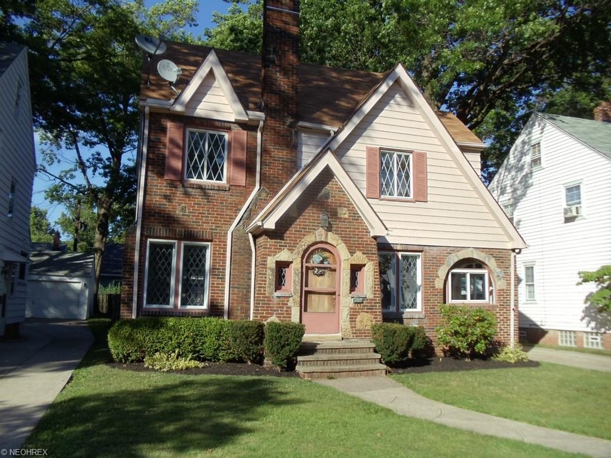 FOUR LEVEL TUDOR ON A BRICK TREE LINED STREET. JUS