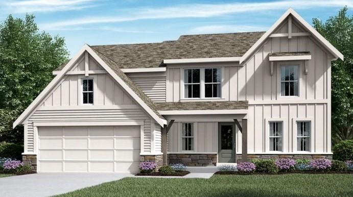 Modern farmhouse featuring a front yard and a gara