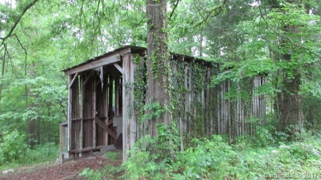 Beautiful wooded lot slopes away from road.