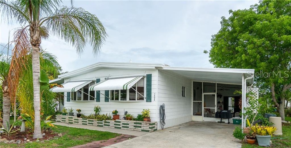 BUY FOR THE NEXT WINTER SEASON or live full time in this 2BD/2BA/1CP CANALFRONT manufactured home in Holiday Mobile Estates w/ access to Lemon Bay.