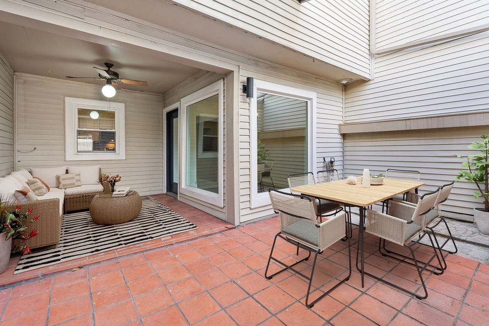 Private courtyard-style patio perfectly situated between the home and garage, Ideal for outdoor dining, relaxing, and entertaining. Photo has been virtually staged for visual reference.