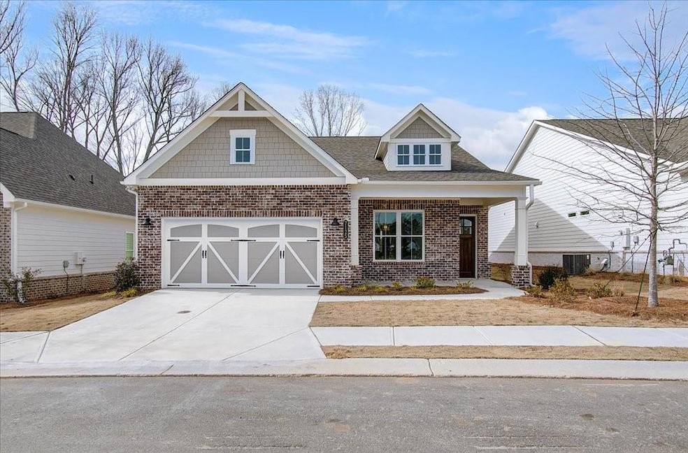 Craftsman house with a garage and central air cond