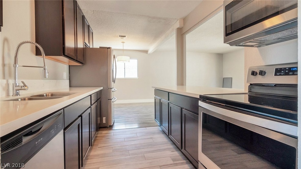 Sleek kitchen features new Quartz counters, new ca