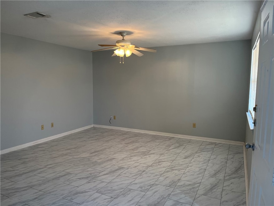 Empty room with light gray laminate  flooring, a c