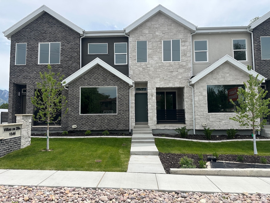 View of front of house featuring stone siding and a front yard