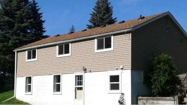 Rear view shows lower level walkout apartment.  Bo