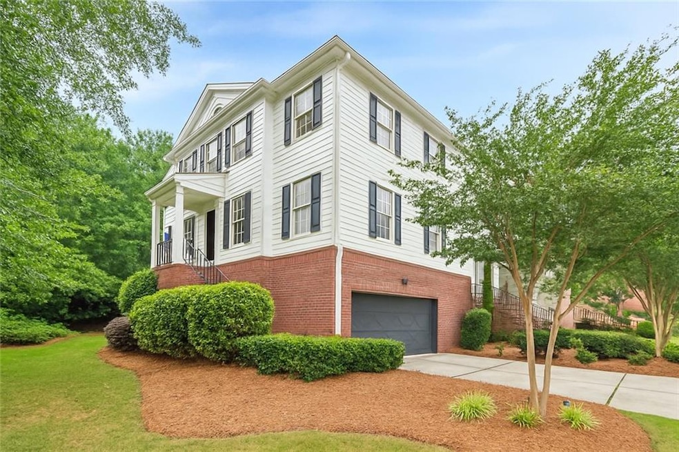 DIGITALLY MODIFIED COLOR of what unit could look like if painted white. View of property exterior with brick siding, driveway, an attached garage, and stairway